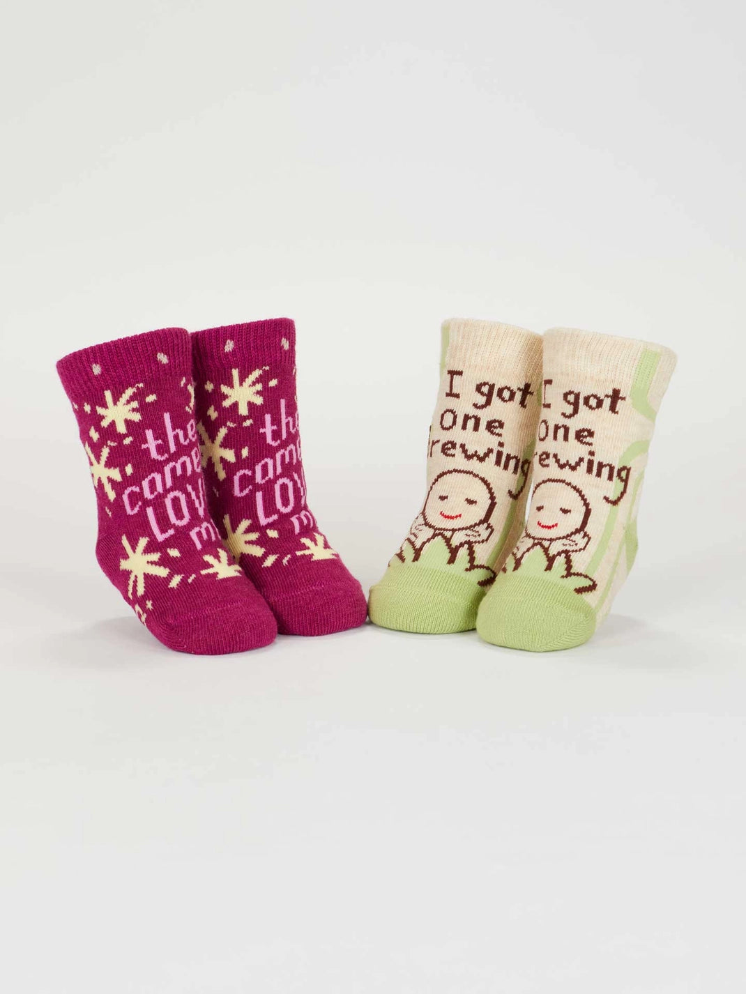 Both pairs of baby socks standing upright