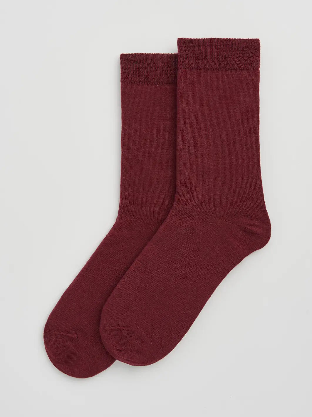 Pair of dark plum merino socks laid flat