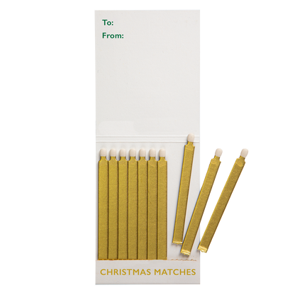 Christmas match book open with a few gold matches pulled out