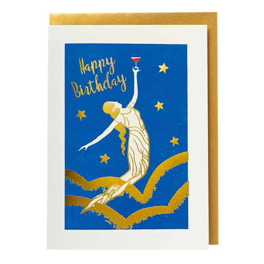 Blue letterpress card with a gold dancing lady raising a glass among stars: Happy birthday