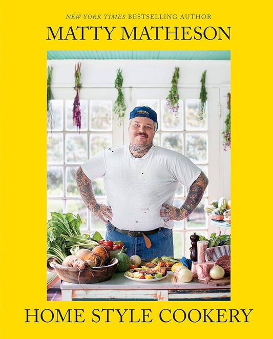 Matty Matheson Home Style Cookery: yellow cover with the chef standing in a kitchen behind a table of food