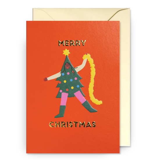 Lagom card: a dancing Christmas tree with legs and a garland, with gold 'Merry Christmas' on red