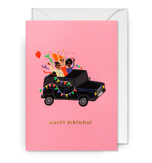Lagom card: friends partying in a black jeep with bunting and balloons, with gold 'Happy birthday' on pink
