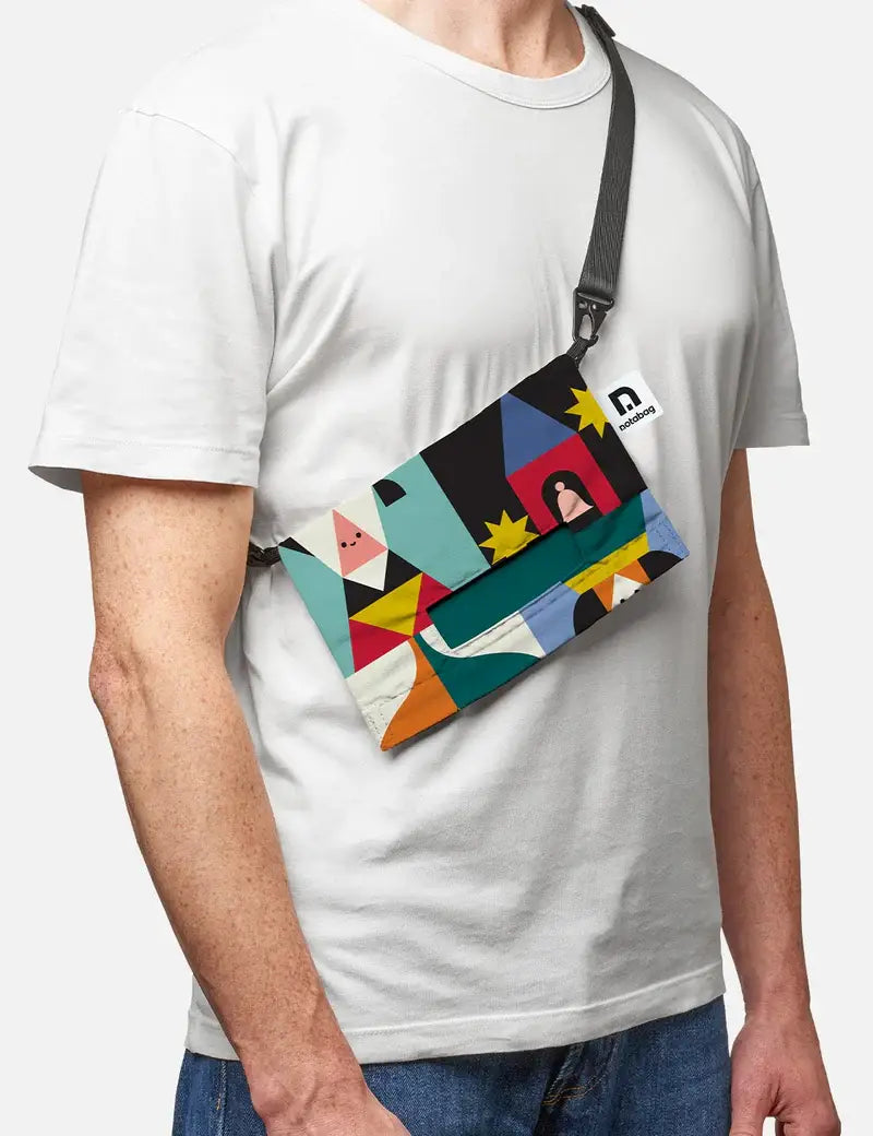 Man wearing the Playground crossbody bag across a white T-shirt