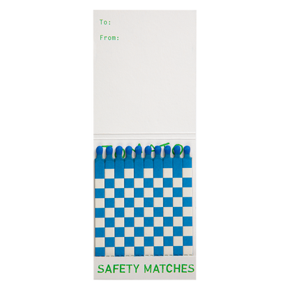 Tomato match book open with a few blue and white matches pulled out