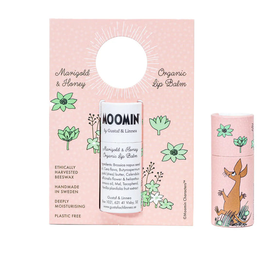 Moomin Sniff marigold and honey organic lip balm on its pink card beside its tube