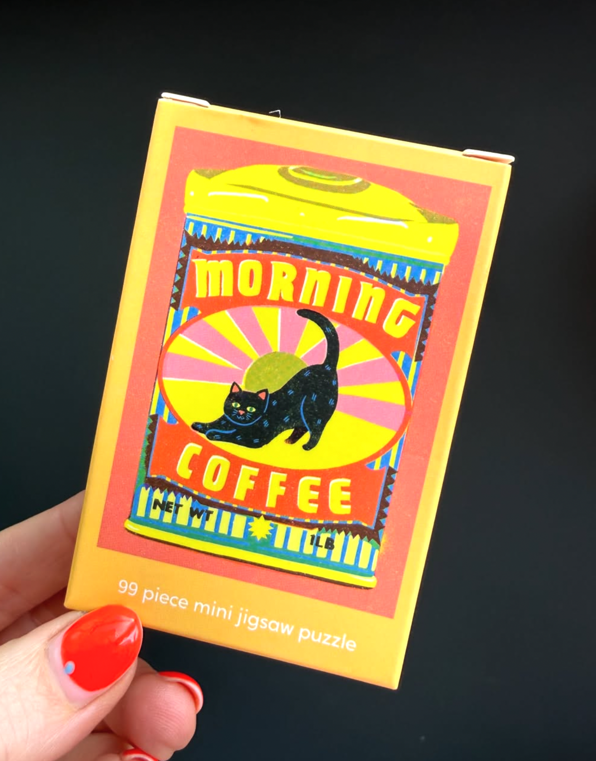 Hand holding the Morning Coffee jigsaw box