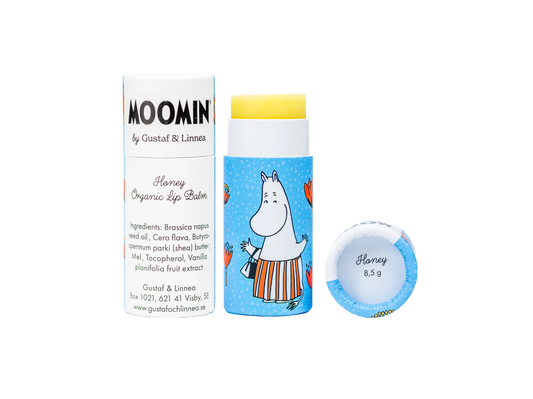 Moominmamma organic honey lip balm stick beside its blue Moomin tube