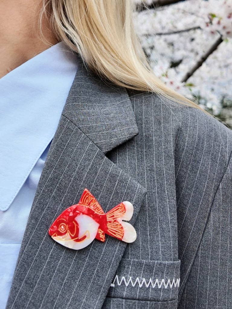 Goldfish brooch on a grey pinstripe blazer
