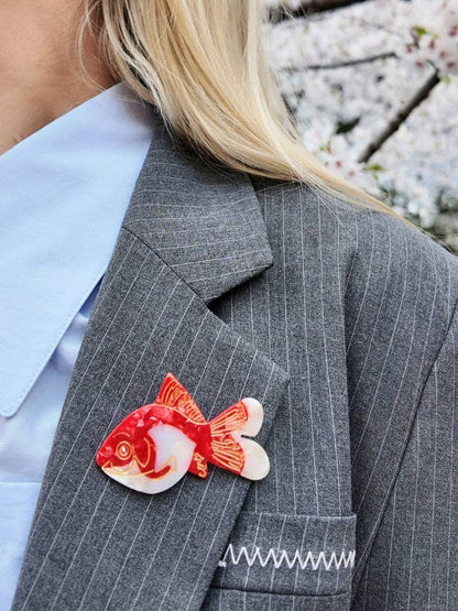 Goldfish brooch on a grey pinstripe blazer