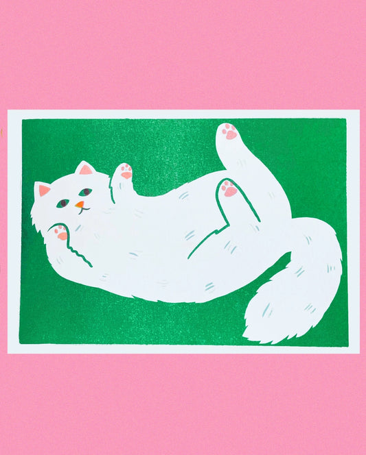 Naomi Wilkinson A4 print: a fluffy white cat lying on its back on green