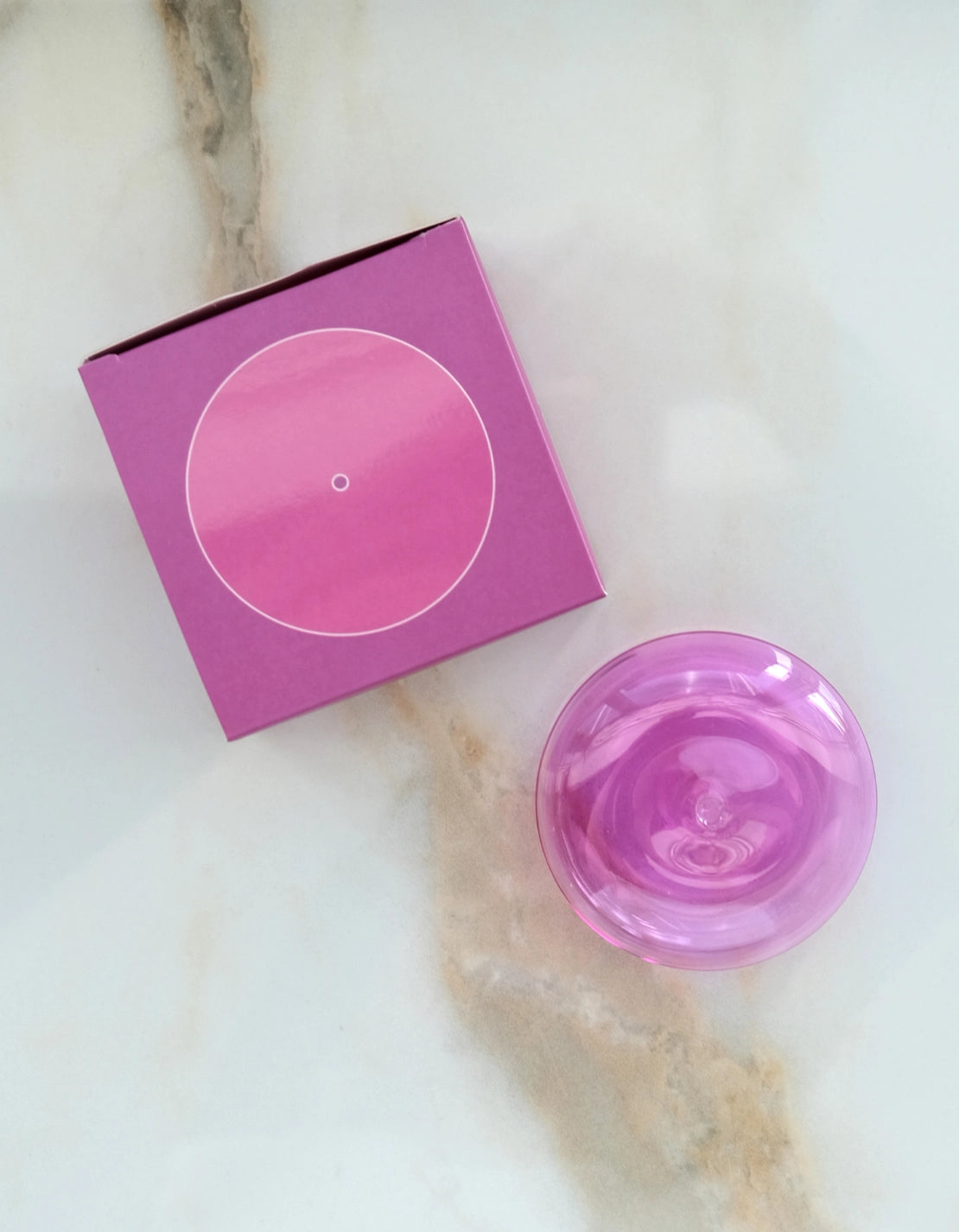 Botanica orchid translucent glass incense holder beside its bright pink box