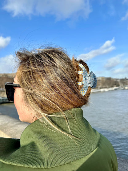 Woman by the water wearing the blue octopus hair clip