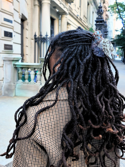 Pigeon clip holding back long locs