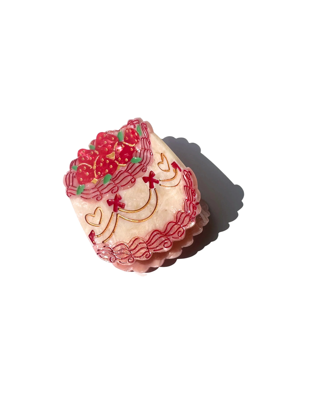 Hair claw clip shaped like a pink iced party cake with red cherries
