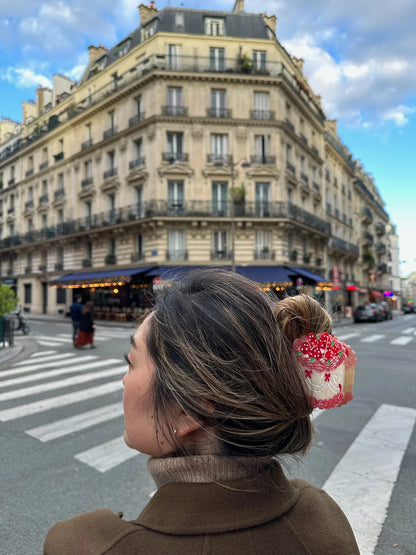 Woman wearing the party cake clip in her hair on a Paris street