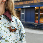 Dachshund brooch on a floral jacket collar