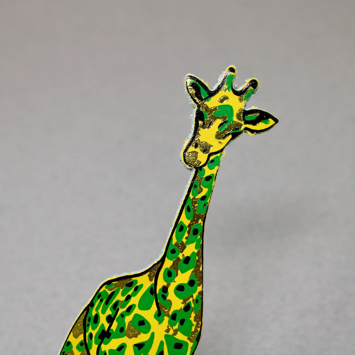 Yellow leather giraffe bookmark with green patches
