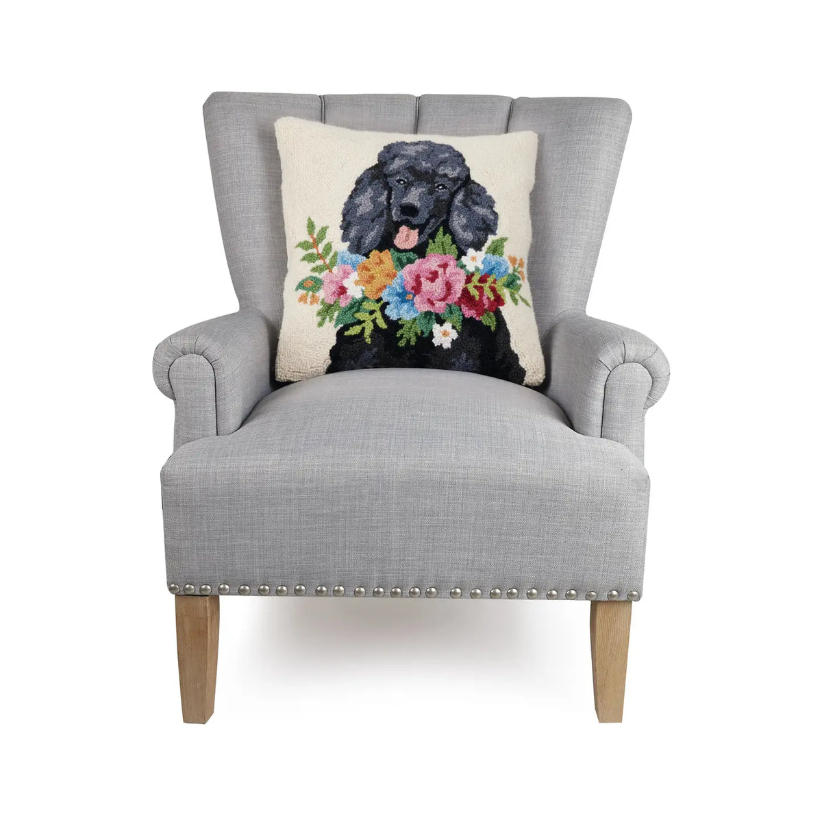 Poodle cushion on a grey armchair