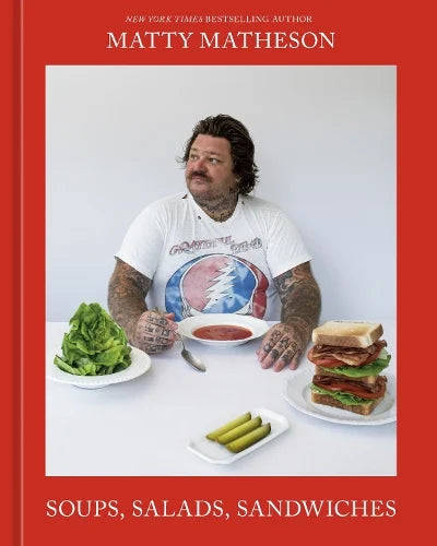 Matty Matheson Soups, Salads, Sandwiches book cover, with the chef at a table of salads and sandwiches