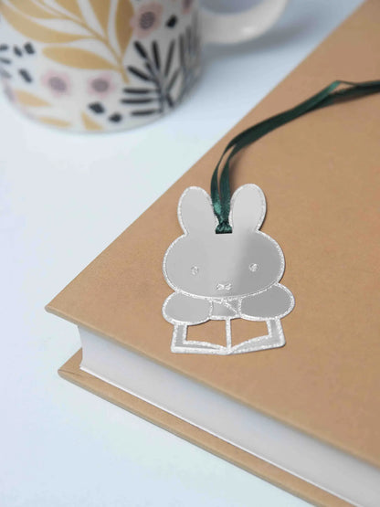 Silver Miffy reading bookmark hanging from the edge of a book