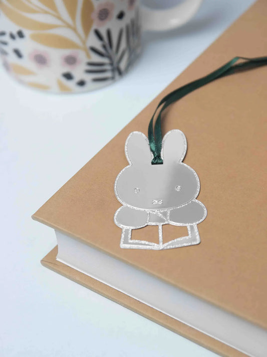 Silver Miffy reading bookmark hanging from the edge of a book