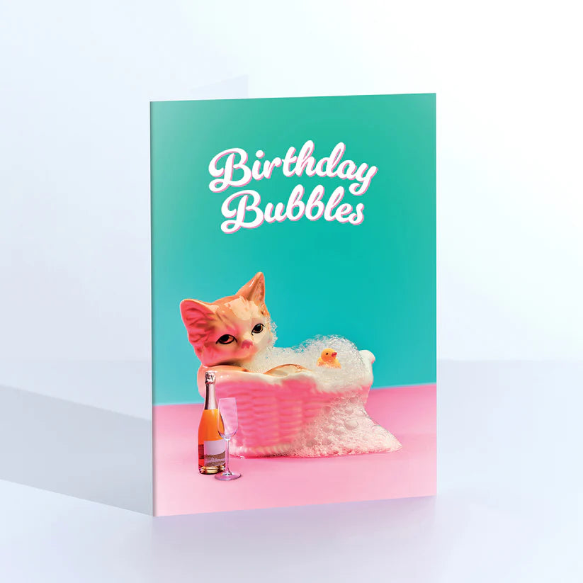 Ornament card: a vintage kitten figurine in a pink bubble bath, with 'Birthday bubbles' on teal