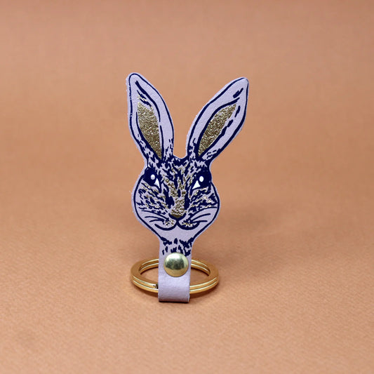 Lilac leather rabbit head key fob with navy line drawing and gold ears