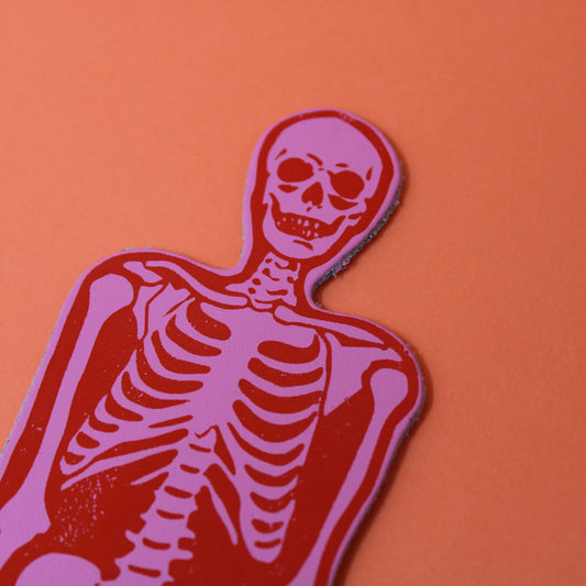 Ark pink and red skeleton bookmark, close-up