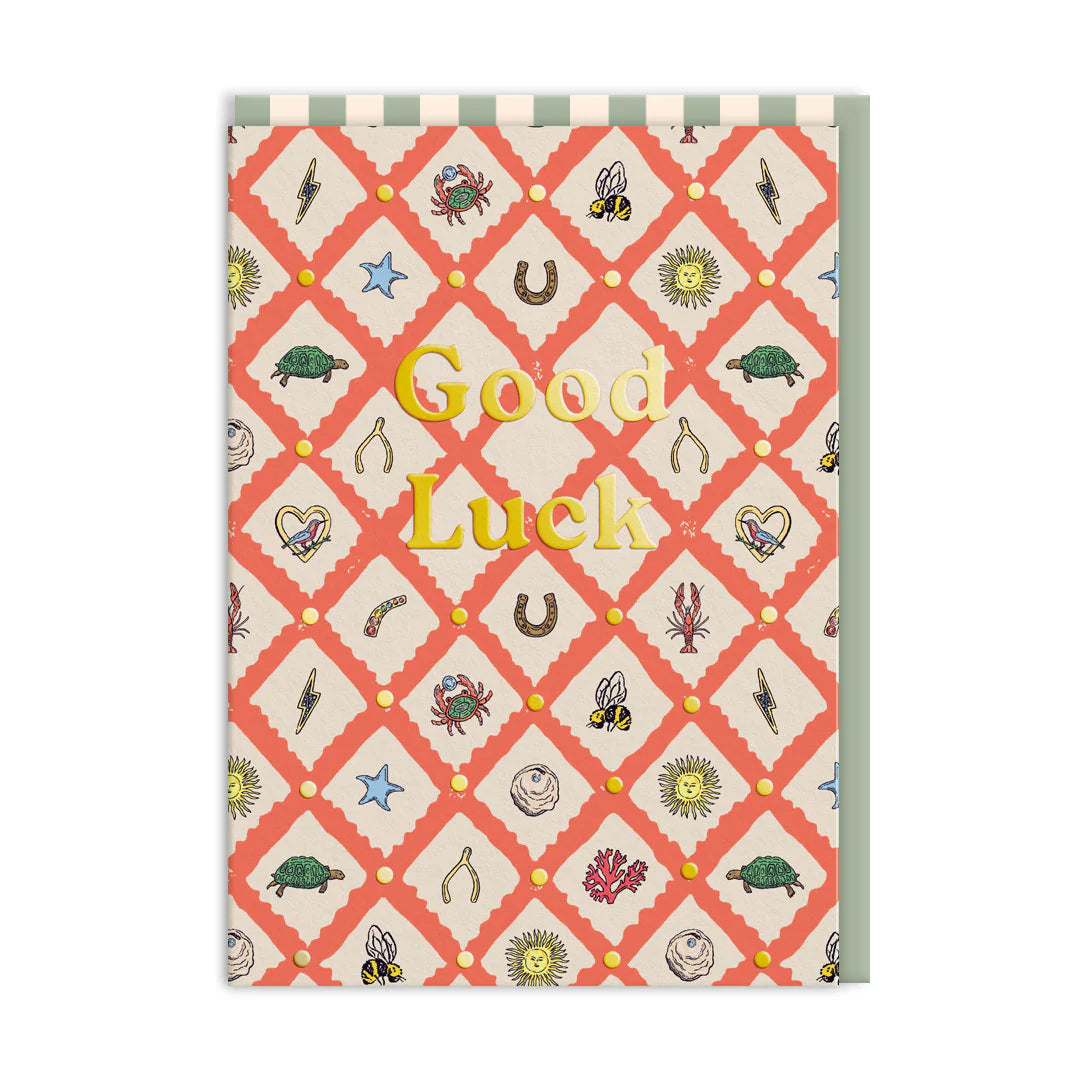 Ohh Deer card: a pattern of lucky charms like horseshoes, clovers and wishbones, with gold 'Good luck'