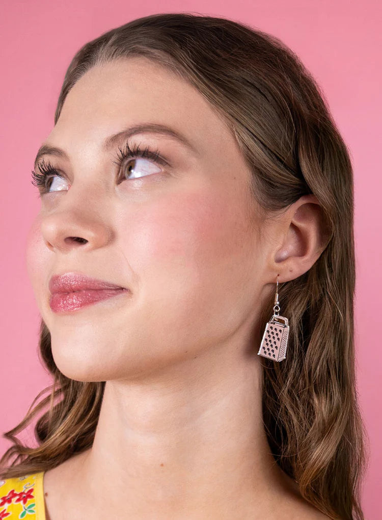 Woman wearing a cheese grater earring