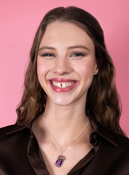 Smiling woman wearing the chocolate bar pendant