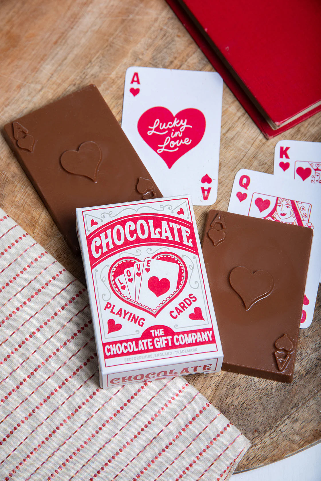 Chocolate Gift Co chocolate playing cards beside heart-themed playing cards
