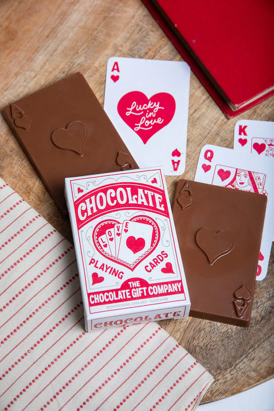 Chocolate Gift Co chocolate playing cards beside heart-themed playing cards