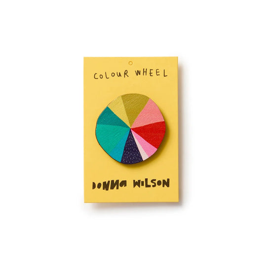 Donna Wilson Colour Wheel pin badge on its yellow card