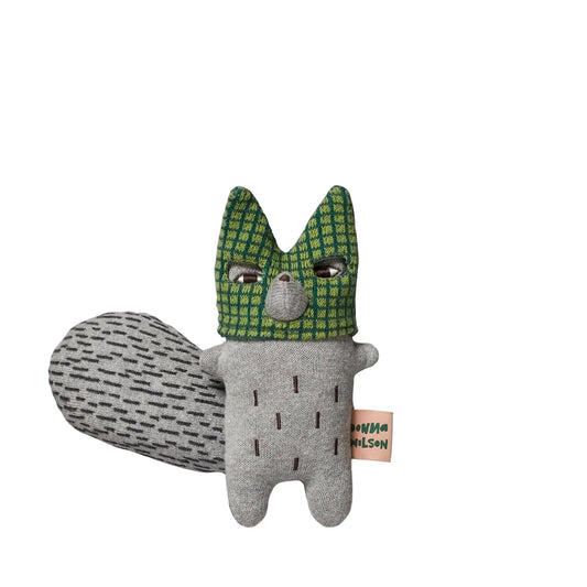 Knitted grey wolf soft toy with a green checked head and a long tail