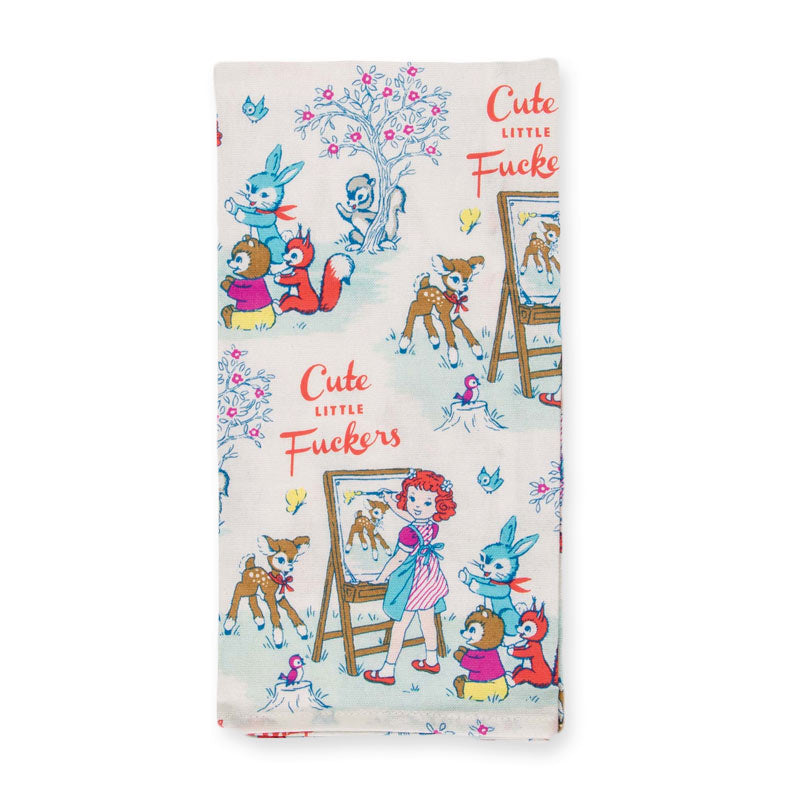 Blue Q 'Cute little fuckers' tea towel, folded: vintage-style rabbits, deer and a girl painting