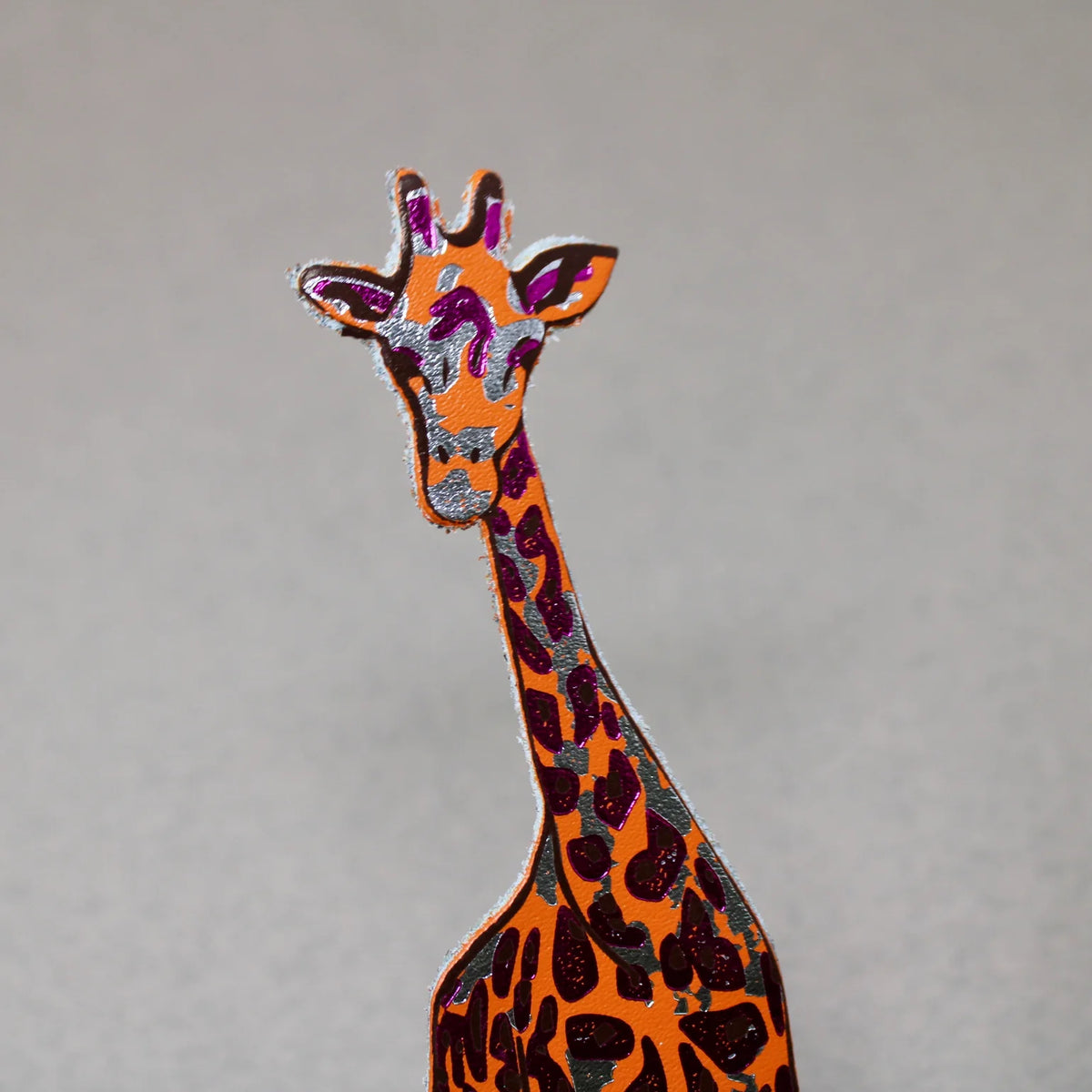 Orange leather giraffe bookmark with brown patches