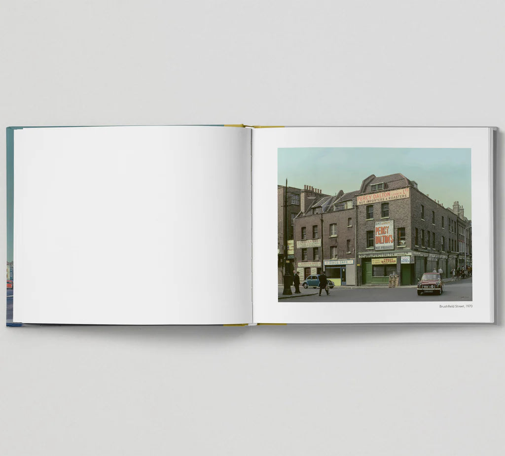 Book open at a colour photo of an East End street corner