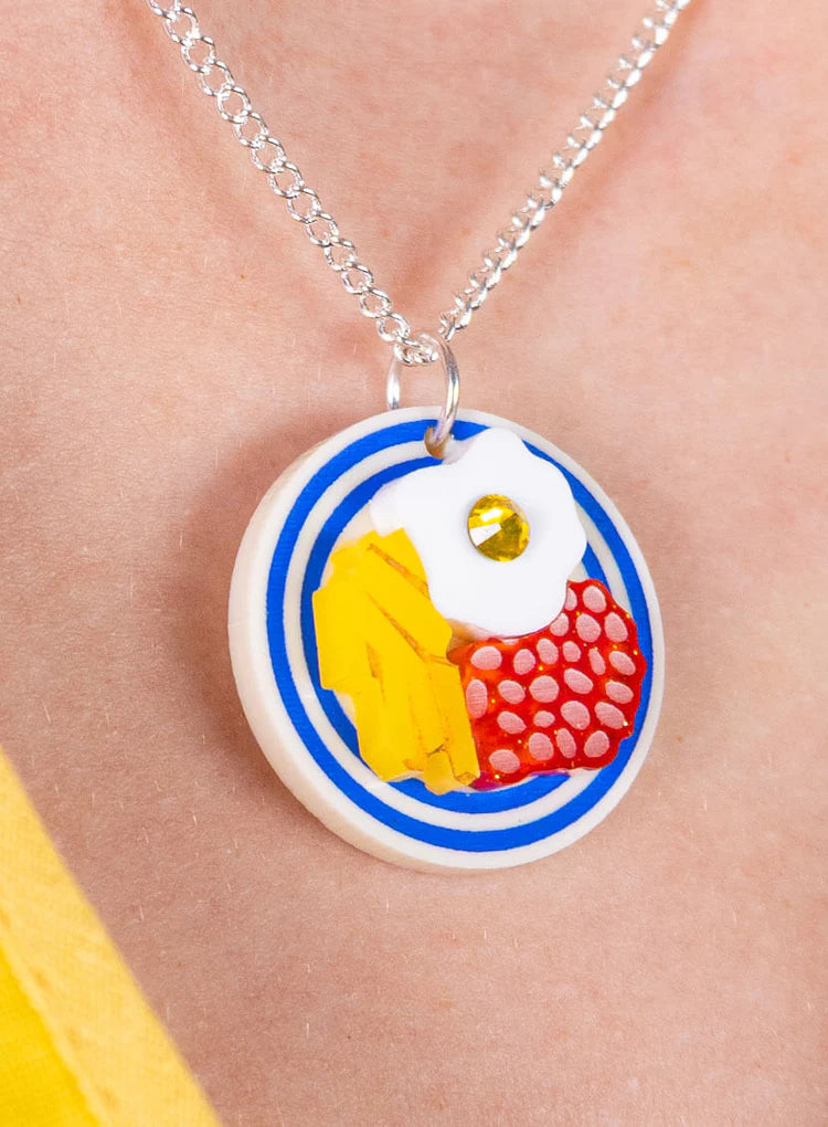 Eggs, chips and beans pendant worn on a silver chain