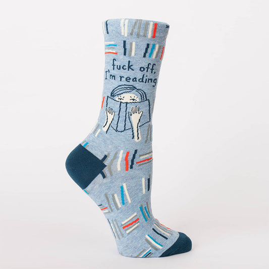 Light blue women's socks with a woman hiding behind a book: Fuck off, I'm reading