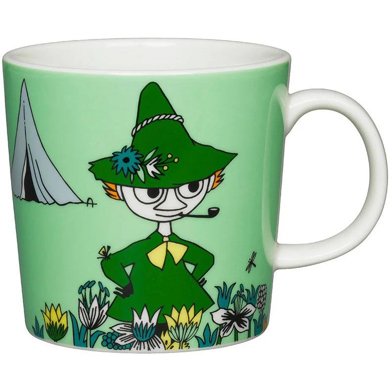 Snufkin mug: Snufkin in his green hat and coat in a meadow, with his tent behind