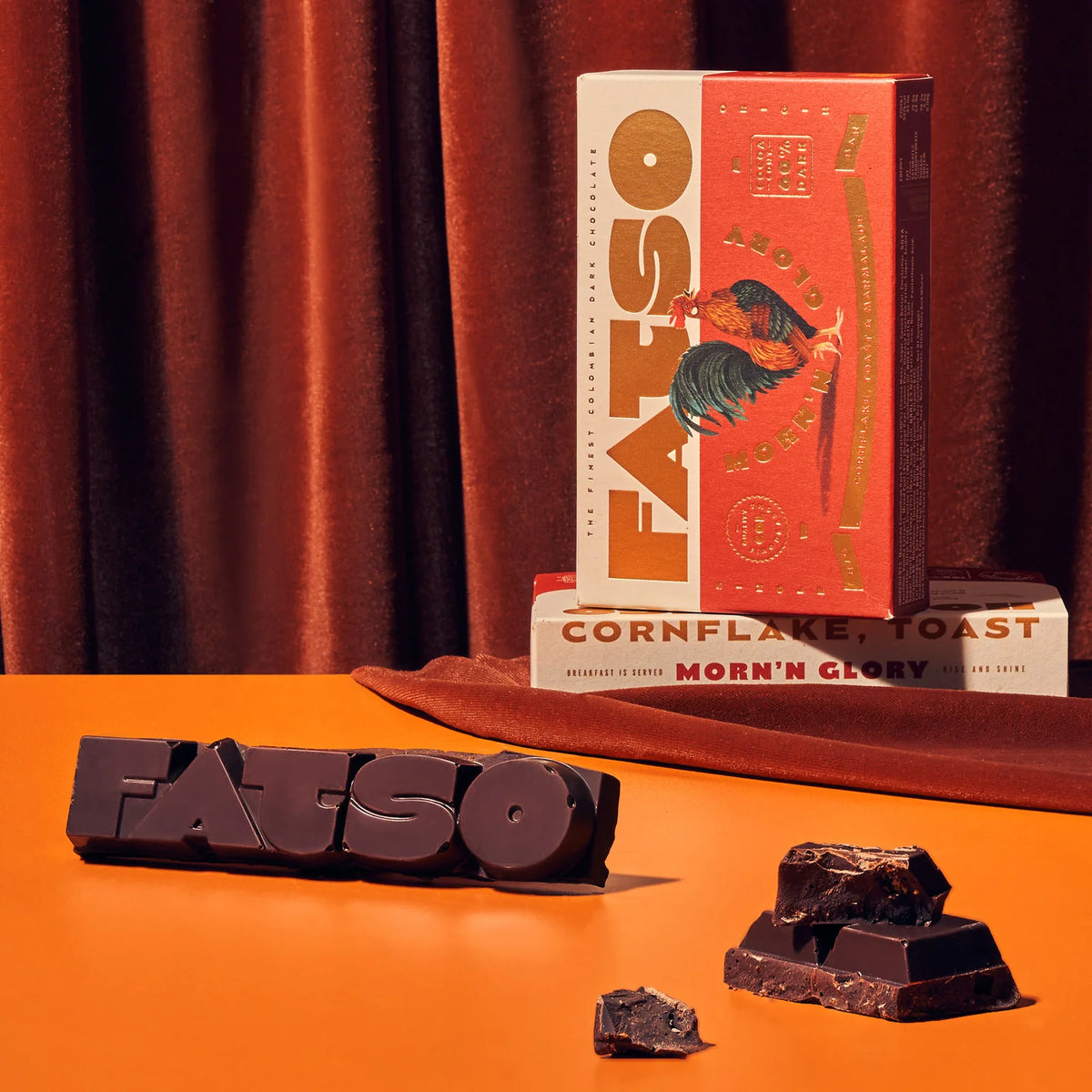 Morn'n' Glory chocolate with Fatso chocolate pieces against a velvet curtain