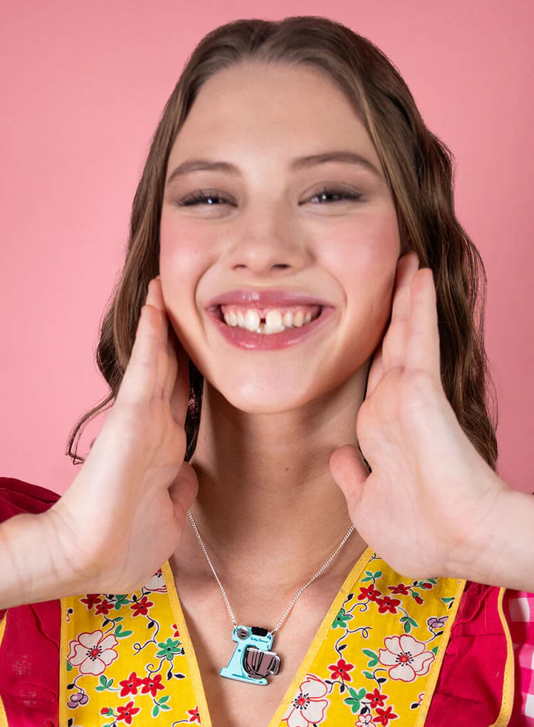 Smiling woman wearing the food mixer necklace