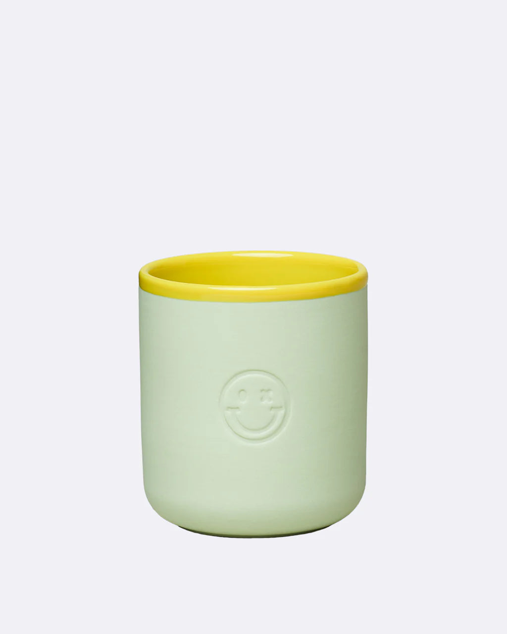 Chic Mic pistachio green cup with a yellow rim and embossed smiley face