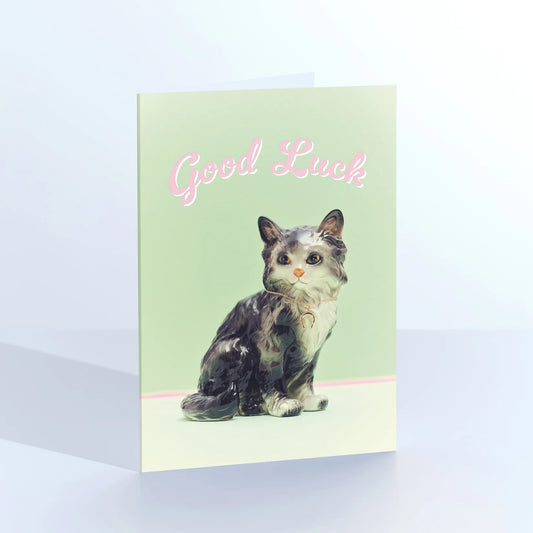 Ornament card: a vintage tabby cat figurine, with 'Good luck' on green