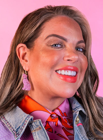 Smiling woman wearing the pink leopard earrings