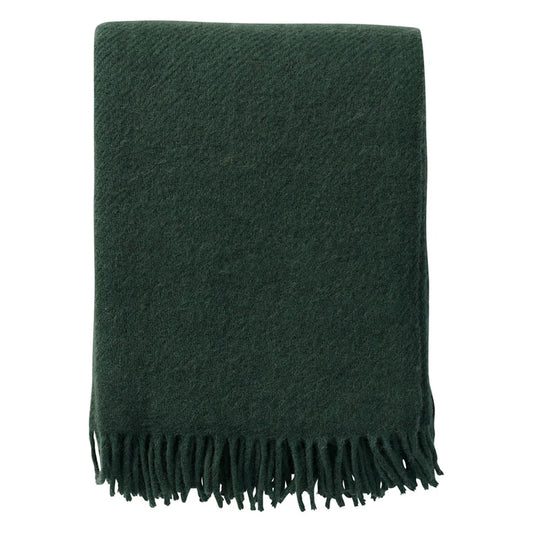 Klippan Gotland blanket in bottle green with fringed ends, folded
