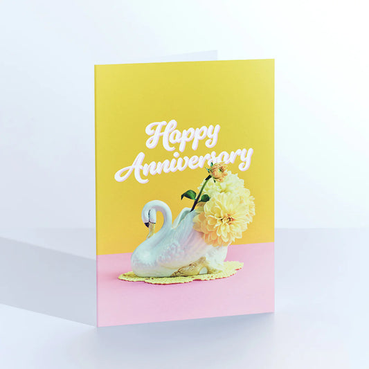 Ornament card: a china swan vase filled with yellow flowers, with 'Happy anniversary' on yellow