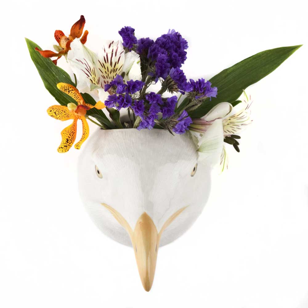 Quail ceramic herring gull wall vase holding purple and orange flowers